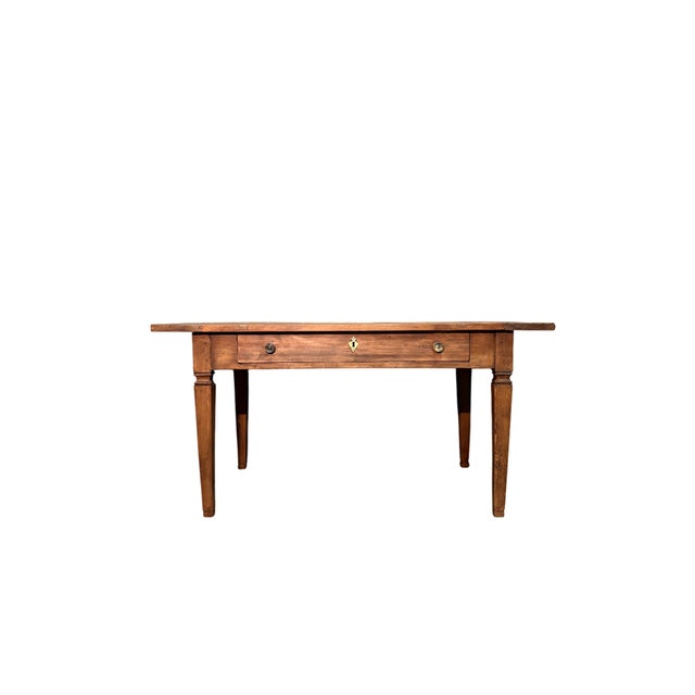Walnut table with tapered leg from the 1800s. It features a large chest of drawers with original lock and key on the front.