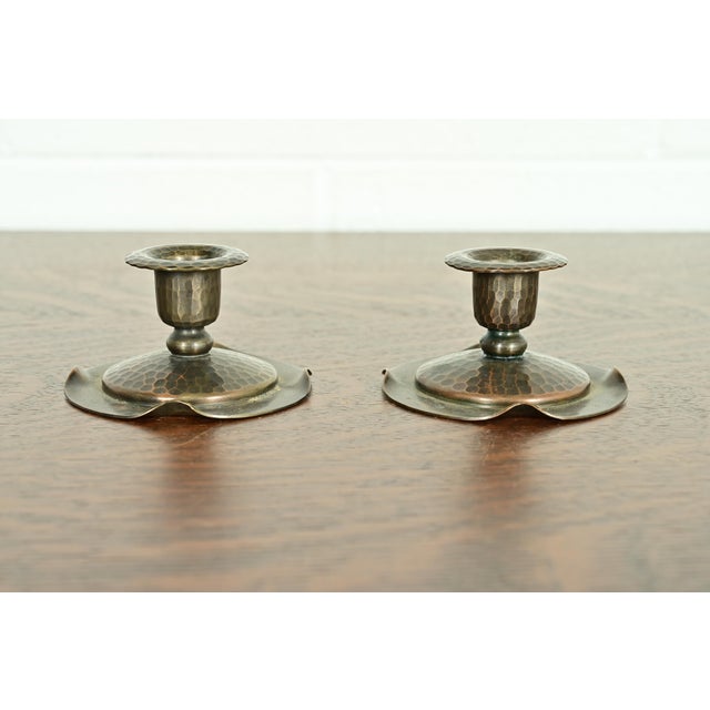 A gorgeous pair of Arts & Crafts period hand hammered copper candlesticks By Roycroft (signed with impressed orb and cross...