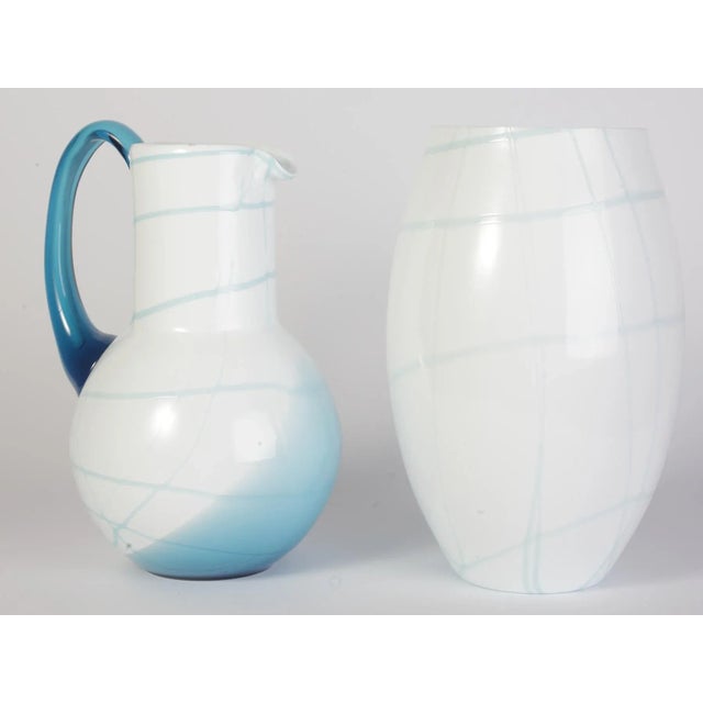 Beautiful craftsmanship of a glass master. Hand made and mold blown. Overlaid white body glass mass with melted blue glass...