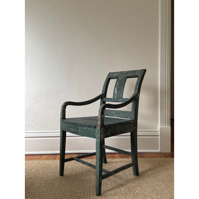 Early 1800's Swedish chair, with the original deep blue paint. Sturdy, with curved arms, a tiered backrest and tapered...