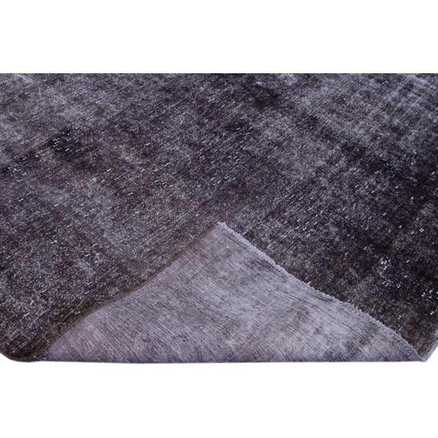 Beautiful vintage all over hand-knotted wool rug with a brown field. This rug has a gorgeous all-over distressed design....