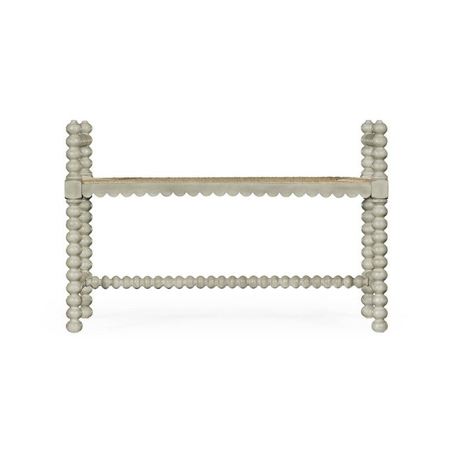 A modern Jacobean single bench constructed of acacia and finished in pale grey paint with a fine rush seat is perfect at...