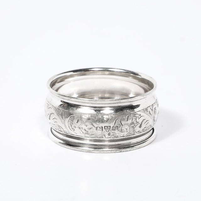 This elegant antique sterling silver napkin ring is a refined example of early 20th-century English craftsmanship. Dating...