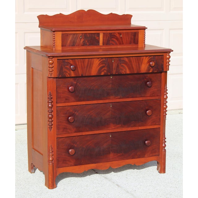 Bring timeless elegance into your home with this early 1900s Empire Revival chest, beautifully crafted from richly figured...