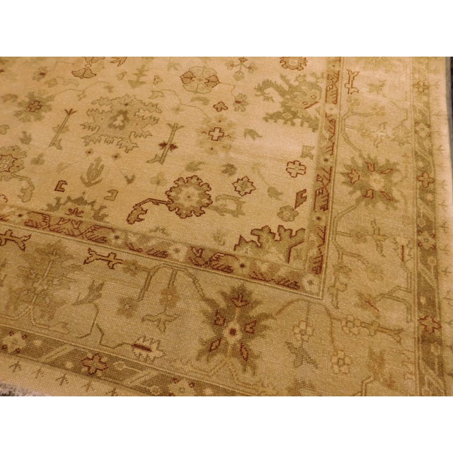 All over geometric motifs on tan background. Wool pile on cotton foundation.