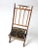 This late 19th century Victorian folding camp chair features a turned wood frame, decorative spindle back with pointed...