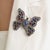 The Boho Chic 10 Ct Tanzanite, Glass-Filled Ruby, Kyanite & Diamond Butterfly Statement Brooch Pendant is crafted in 925...