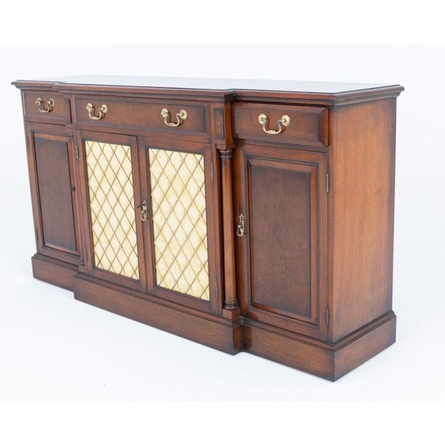 Elegant Georgian Revival walnut breakfront sideboard of impressive proportions and quality craftsmanship Raised on a...