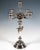 Tall, festive silver candelabrum on a stepped, funnel-shaped base; baluster shaft featuring an inlaid, stylised amphora-...