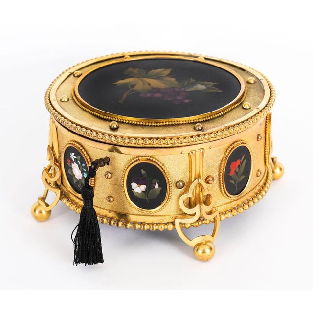 An extravagant Gilt Bronze and Pietra Dura jewellery casket, Circa 1860 in date. The stunning ormolu casket of circular...