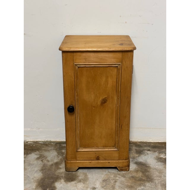 This antique English pine pot cupboard nightstand is a charming and practical piece, full of warmth and character. The...