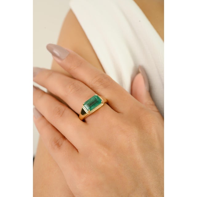 Introducing our 14K Gold octagon cut emerald Signet Ring, showcasing 2.76 ct of emerald in a sleek prong setting. This...