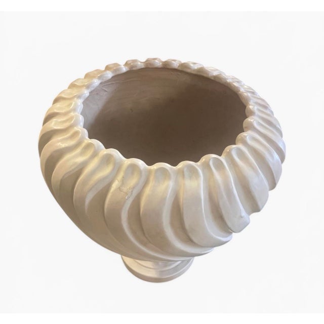 Elegant and sculptural, this pair of Italian ceramic urns showcases a refined spiral (twisted gadroon) motif that wraps...