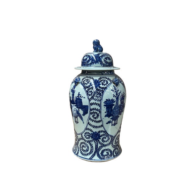 This exquisite blue and white porcelain ginger jar features an ornate, paneled design painted in rich cobalt tones against...