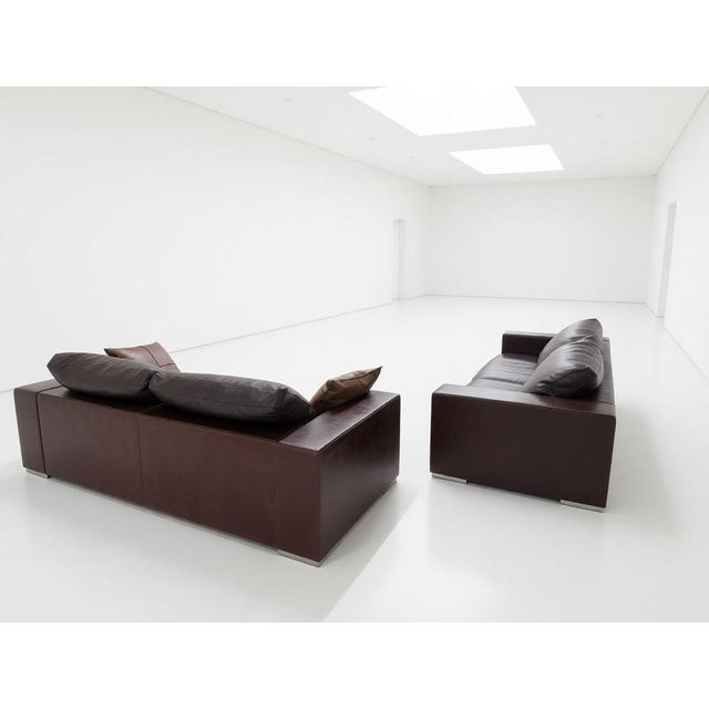 Elegant brown leather sofas in dark brown and burnt brown, available in a large three-seater and a large two-seater....