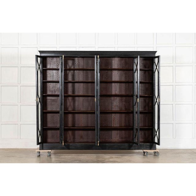 Circa 1880 Large 19thC English Glazed Ebonised Mahogany Bookcase W218.5 x D31 x H183 cm Internal shelf depth 22.5 cm...