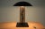 This table lamp was produced by Kamenický Šenov (marked with paper label) in the 1980s. European Plug (up to 250V).The...