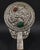 Ornately wrought silver & jade hand-mirror with gemstone inlay. Featuring a Chinese key pattern surrounding a bird-like...