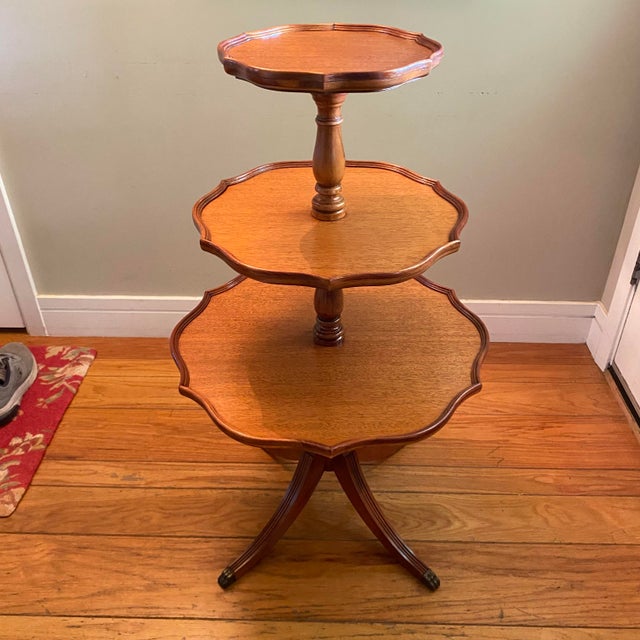 Traditional George III or Duncan Phyfe revival style mahogany 3 tiered side/ dumbwaiter table. It has scalloped rims on...