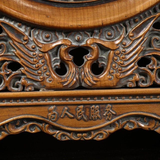 A vintage Chinese carved hardwood table screen, circular in form and mounted on an ornate openwork stand. The central...
