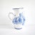 A vintage Czech ceramic pottery pitcher by Modra Slav Keramika, hand-painted with blue and white flowers in a folk design....