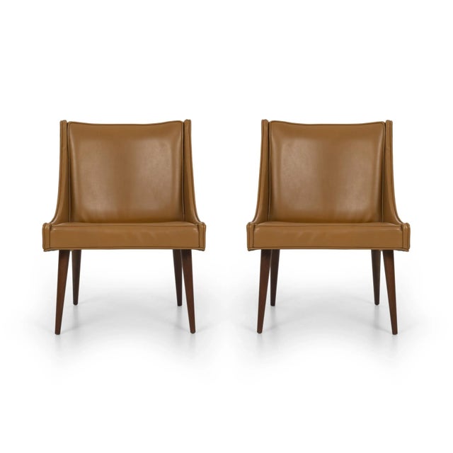 Pair of Milo Baughman slipper chairs for Thayer Coggin, original vinyl upholstery with solid turned walnut legs. (Multiple...