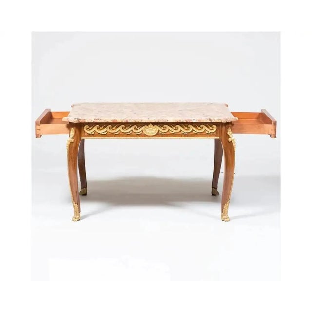 A French Louis XVI Style Ormolu-Mounted Mahogany Coffee Table, C. 1880 fitted with a Breche d 'Alep marble top and two end...
