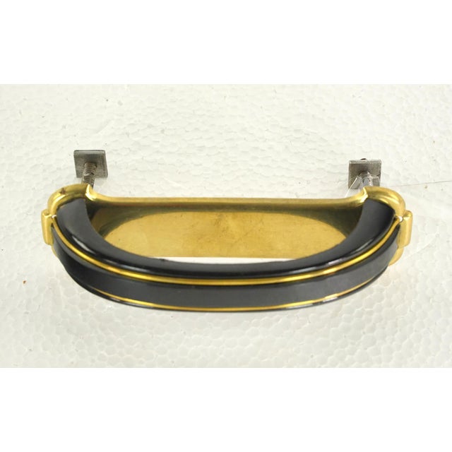 1950s drawer or cabinet pull made of black plastic and gold finish steel. Mounting screws are included. Good condition...