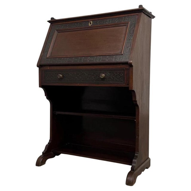 A handsome and finely crafted 20th-century English bureau, constructed from mahogany and designed in the Chippendale...