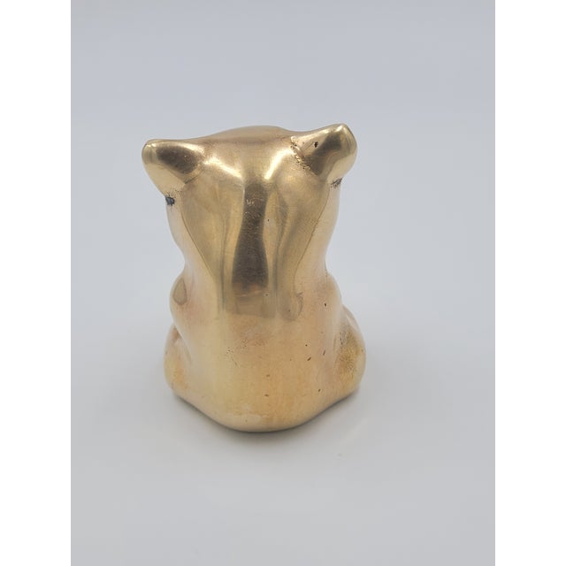 A charming Mid-Century Modern solid brass panda bear figurine, captured in a whimsical seated pose. This vintage piece...