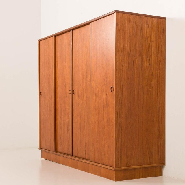 This danish mid-century teak wardrobe was made by laurbjerg møbelfabrik in the 1970s. it embodies the timeless principles...