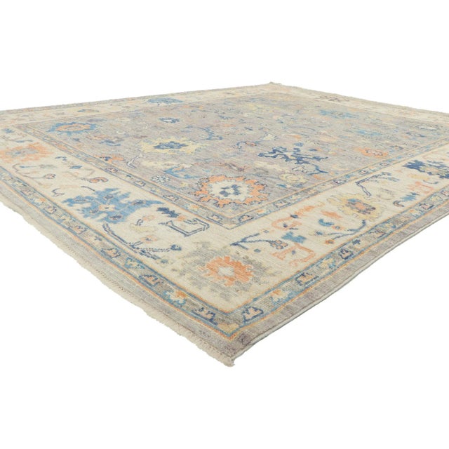 Polished and playful, this hand-knotted wool colorful Oushak rug beautifully embodies a modern style. The composition...