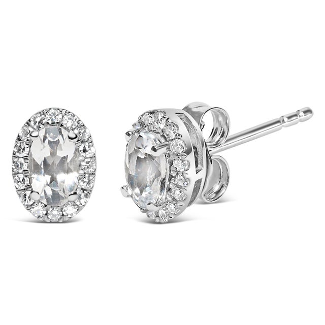 Drape your ears in the enchanting allure of these 10k white gold stud earrings, meticulously crafted with rhodium plating...