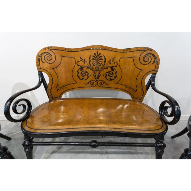 Tresillo consisting of a two-seater canape and two chairs with bent beech wood arms. Structure in black-patinated beech,...