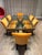 Striking vintage dining table featuring a sculptural wrought iron base paired with a substantial rectangular glass top....