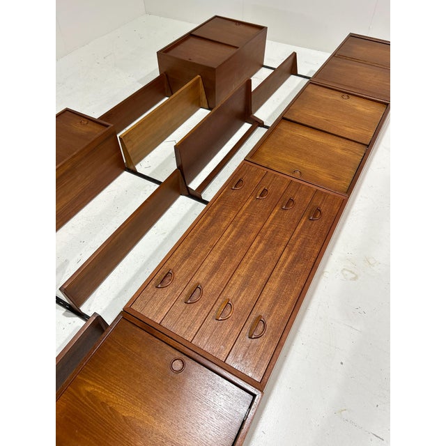 A stunning teak modular wall system designed by kai kristiansen for fm møbler (feldballes møbelfabrik), denmark, in the...