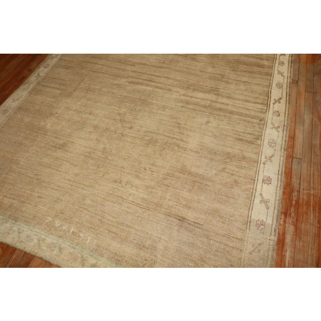 mid 20th Century Turkish Kars rug with an open field design in light brown and khaki, touches of pink as well