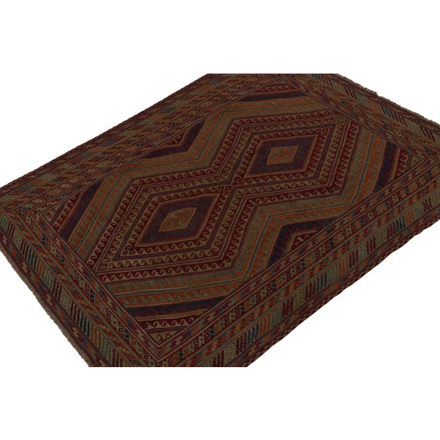 Hand-knotted in wool circa 1950-1960, this vintage 7x9 Baluch tribal rug is an exciting new curation from Rug & Kilim. On...