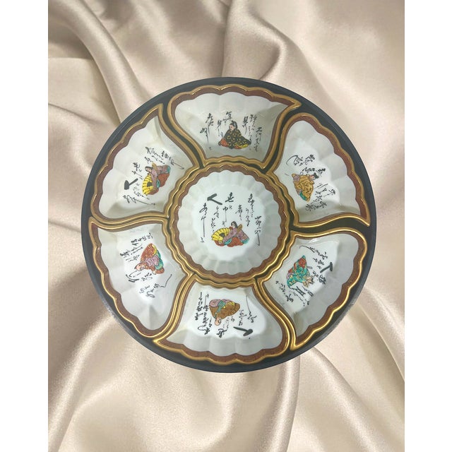 A very nice signed Kutani sweetmeat tray (hors d'oeuvres) consisting of 7 porcelain bowls and the tray which rests on a...