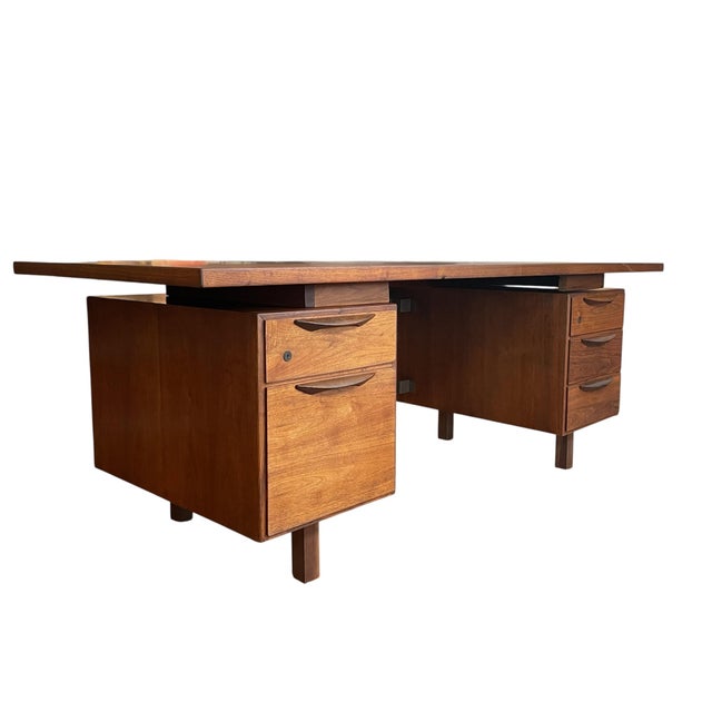 Extraordinary and rare large Jens Risom executive desk in walnut, featuring five drawers. This amazing piece remains in...