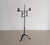 An unusual antique hand-wrought iron standing candleholder, dating to the late 18th. The tall central shaft is fitted with...