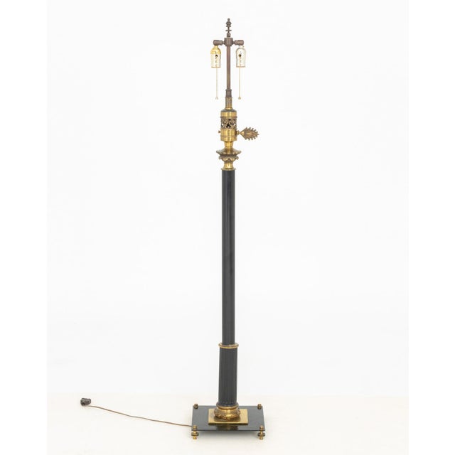 Neoclassical Style Ebonized and Gilt Metal Floor Lamp, with two bulb fittings and fluted column accent above square base....