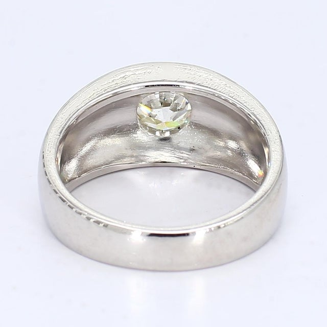 This is a size 7.5 platinum signet ring with a single central old European cut diamond weighing approximately 0.84cts and...