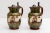 A set of 1851-1898 Belgium majolica pitchers, pottery jugs with pewter top.White hand painted cherubs sitting in a...