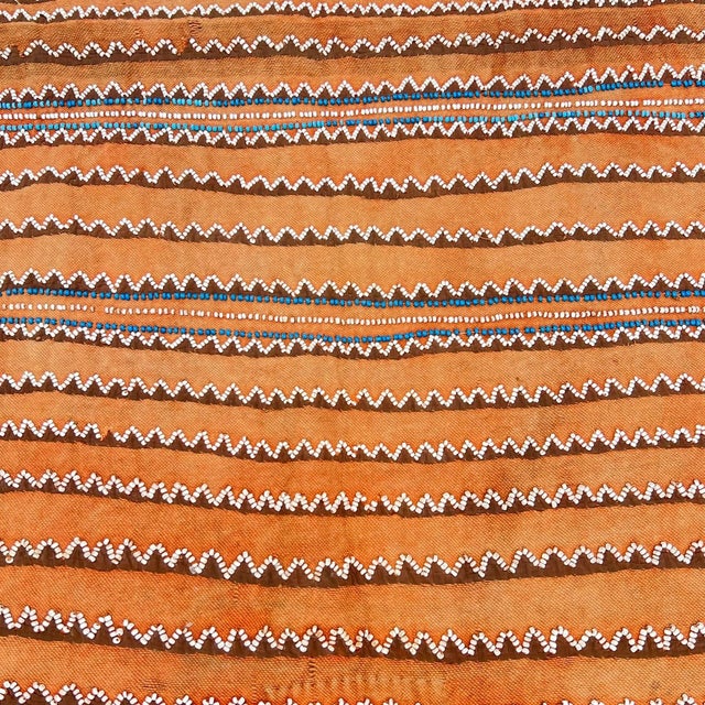 Traditional Southern African cotton textile featuring striking geometric white and blue patterned bands associated with...