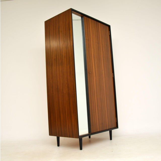 A beautifully designed and extremely well made vintage walnut wardrobe by John & Sylvia Reid for Stag. This was made in...