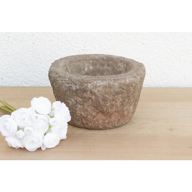 This heavy stone mortar is a relic of the "Old World" kitchen. Carved from a single block of solid granite, it was...