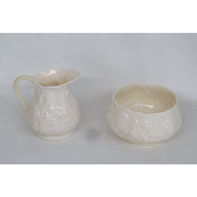 This lovely Creamer and Sugar Bowl set is made out of porcelain. This set is stamped as being made by Belleek in Ireland....