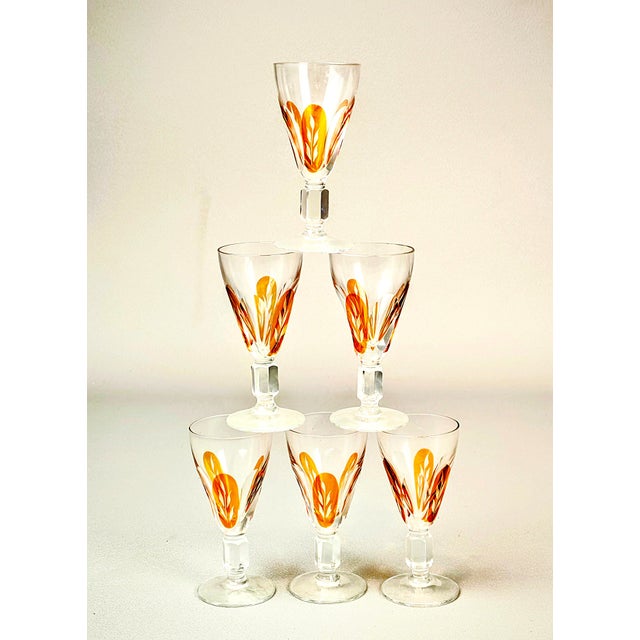 Clear, crystal glass. Characterized by gold, leafy, or petal-like patterns that adorn the lower part of each bowl and the...