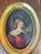 A captivating small cabinet portrait of a young boy in 17th-century cavalier dress — plumed hat, flowing hair, and an...
